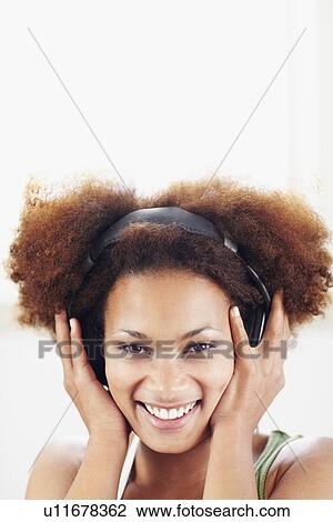 Stock Image - Woman listening to music. Fotosearch