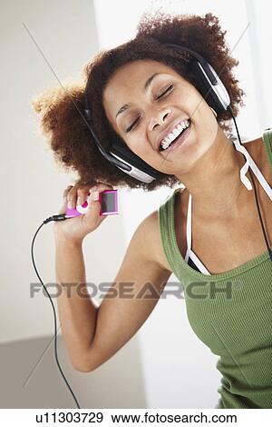 Stock Photo - Woman listening to music. Fotosearch