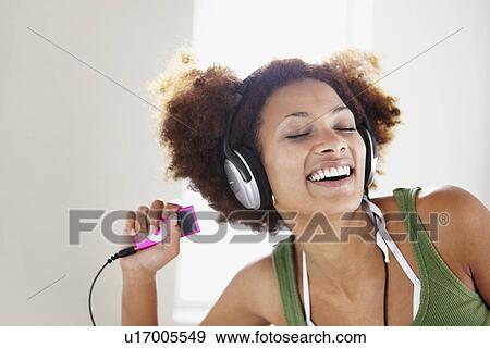 Stock Photo - Woman listening to music. Fotosearch