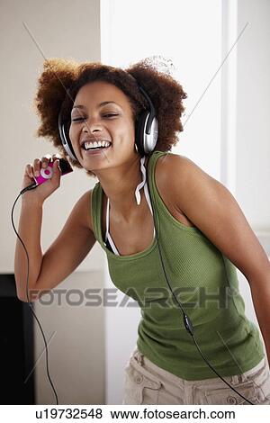 Woman listening to music View Large Photo Image Stock Photo - Woman listening to music. Fotosearch