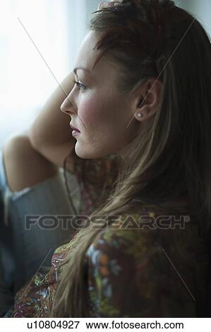 Woman looking out window View Large Photo Image Stock Photo - Woman looking out window. Fotosearch