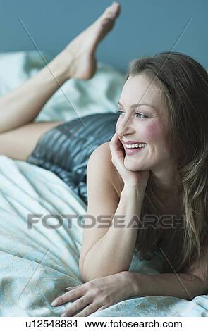 Picture - Woman lying down. Fotosearch