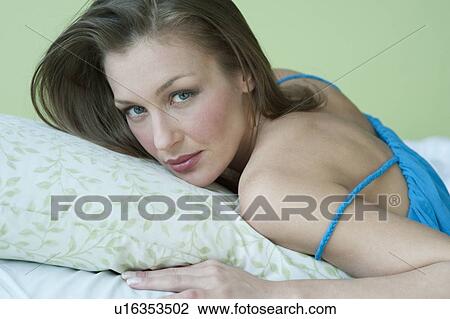 Stock Image - Woman lying down. Fotosearch