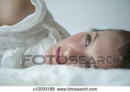 Stock Photo - Woman lying down. Fotosearch