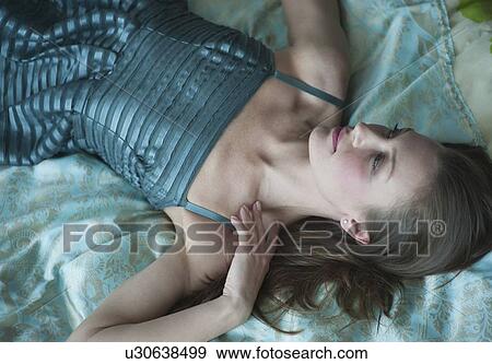 Stock Photo - Woman lying down. Fotosearch