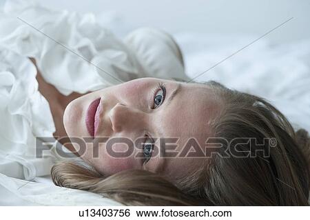 Stock Photograph - Woman lying down. Fotosearch