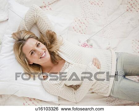 Stock Photograph - Woman lying down. Fotosearch