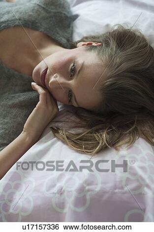 Woman lying down View Large Photo Image Stock Photograph - Woman lying down. Fotosearch