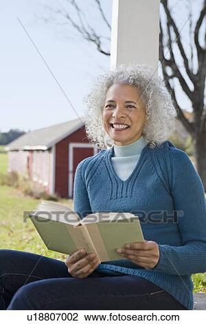 Woman reading a book View Large Photo Image Stock Image - Woman reading a book. Fotosearch