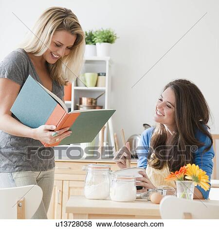 Woman reading book in kitchen View Large Photo Image Stock Photo - Woman reading book in kitchen. Fotosearch