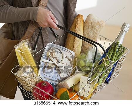 Picture - Woman shopping for groceries. Fotosearch