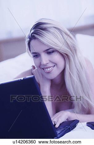 Stock Image - Woman typing on laptop. Fotosearch