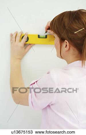 Woman using a level View Large Photo Image Stock Image - Woman using a level. Fotosearch