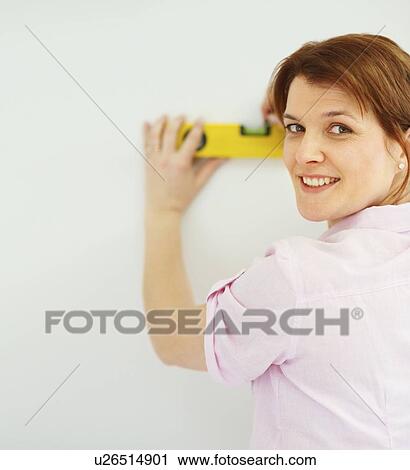 Woman using a level View Large Photo Image Stock Image - Woman using a level. Fotosearch