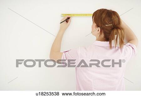 Woman using measuring tape View Large Photo Image Stock Photo - Woman using measuring tape. Fotosearch
