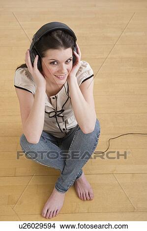 Woman wearing headphones View Large Photo Image Picture - Woman wearing headphones. Fotosearch