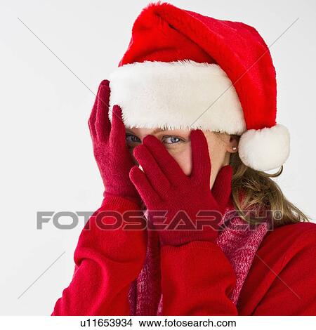 Picture - Woman wearing Santa hat. Fotosearch