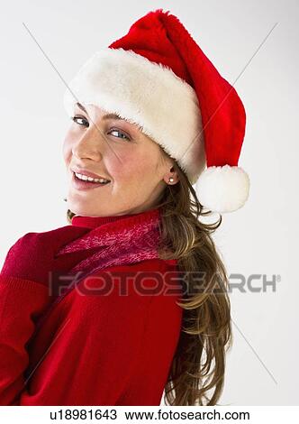 Stock Image - Woman wearing Santa hat. Fotosearch