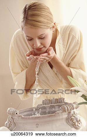 Stock Photo - Women washing her face. Fotosearch