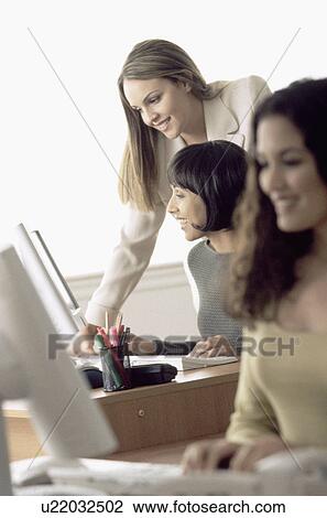 Stock Image - Women working in office. Fotosearch