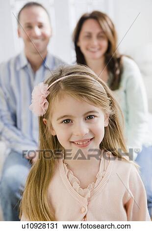 Stock Image - Young girl and her parents. Fotosearch