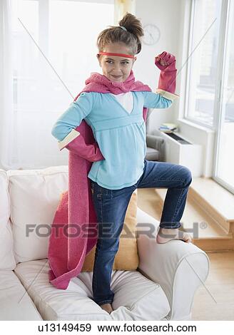 Stock Photo - Young girl dressed up as a superhero. Fotosearch