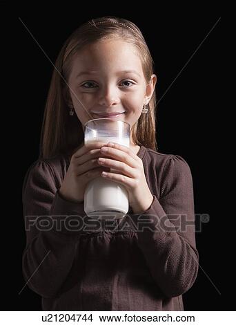 Picture - Young girl drinking glass of milk. Fotosearch