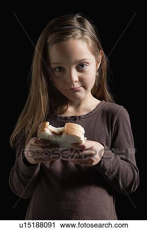 Young girl eating a sandwich View Large Photo Image Stock Image - Young girl eating a sandwich. Fotosearch