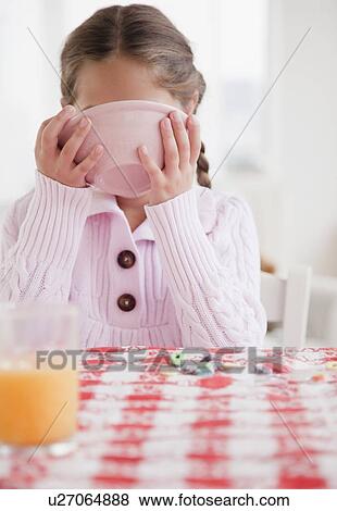 Stock Photo - Young girl eating. Fotosearch