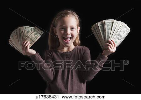 Stock Image - Young girl holding money. Fotosearch