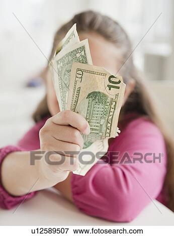 Young girl holding money View Large Photo Image Stock Photo - Young girl holding money. Fotosearch