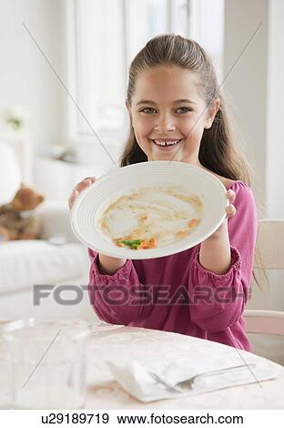 Stock Photo - Young girl holding plate. Fotosearch