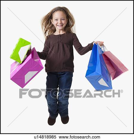 Young girl holding shopping bags View Large Photo Image Stock Photography - Young girl holding shopping bags. Fotosearch