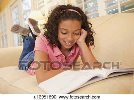 Young girl on couch View Large Photo Image Stock Image - Young girl on couch. Fotosearch