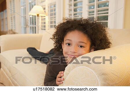 Young girl on couch View Large Photo Image Stock Image - Young girl on couch. Fotosearch