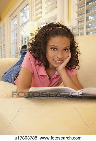 Young girl on couch View Large Photo Image Stock Photo - Young girl on couch. Fotosearch