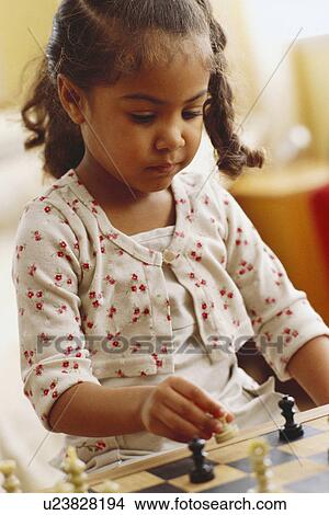 Picture - Young girl playing chess. Fotosearch