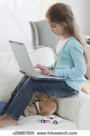 Young girl typing on laptop View Large Photo Image Stock Photography - Young girl typing on laptop. Fotosearch