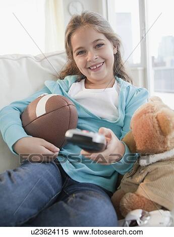 Young girl watching television View Large Photo Image Stock Photography - Young girl watching television. Fotosearch