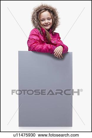 Stock Image - Young girl wearing winter coat. Fotosearch