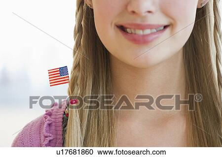 Stock Image - Young girl with American flag in hair. Fotosearch