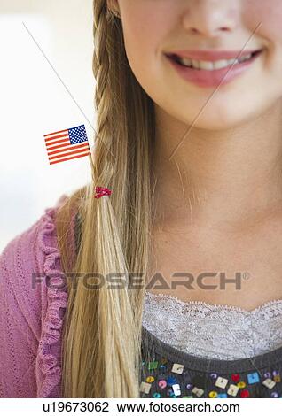 Stock Image - Young girl with American flag in hair. Fotosearch