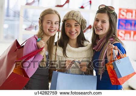 Young girls shopping View Large Photo Image Stock Photo - Young girls shopping. Fotosearch