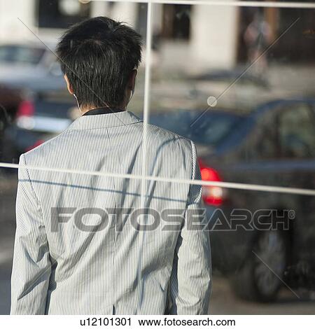 Stock Image - Back view of a Man on street in Chicago. Fotosearch