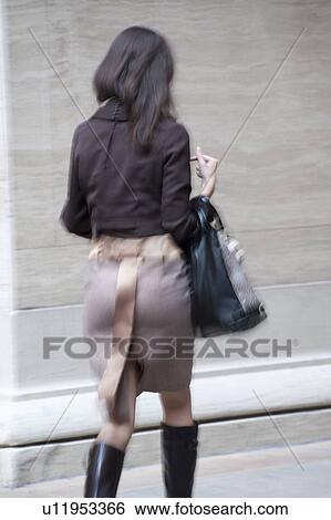 Stock Photograph - Back view of a Woman on the streets in Chicago. Fotosearch