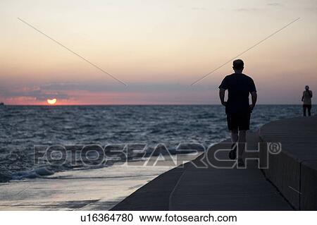 Stock Image - Man jogging at Chicago, Lake Michigan. Fotosearch