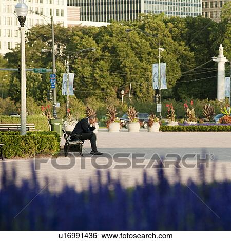 Man sitting on a bench in Chicago Park View Large Photo Image Stock Photograph - Man sitting on a bench in Chicago Park. Fotosearch