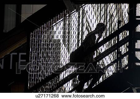 Silhouette of a person walking up on staircase in Chicago View Large Photo Image Stock Photo - Silhouette of a person walking up on staircase in Chicago. Fotosearch