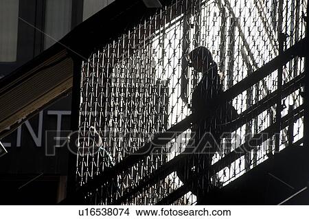 Silhouette of a woman walking down a staircase in Chicago View Large Photo Image Picture - Silhouette of a woman walking down a staircase in Chicago. Fotosearch