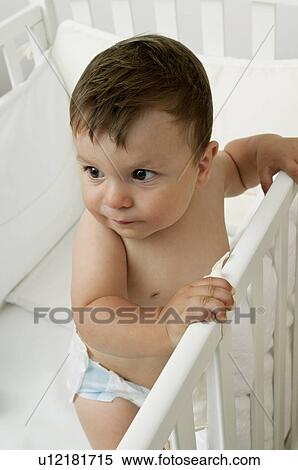 Stock Photography - Baby boy in crib. Fotosearch